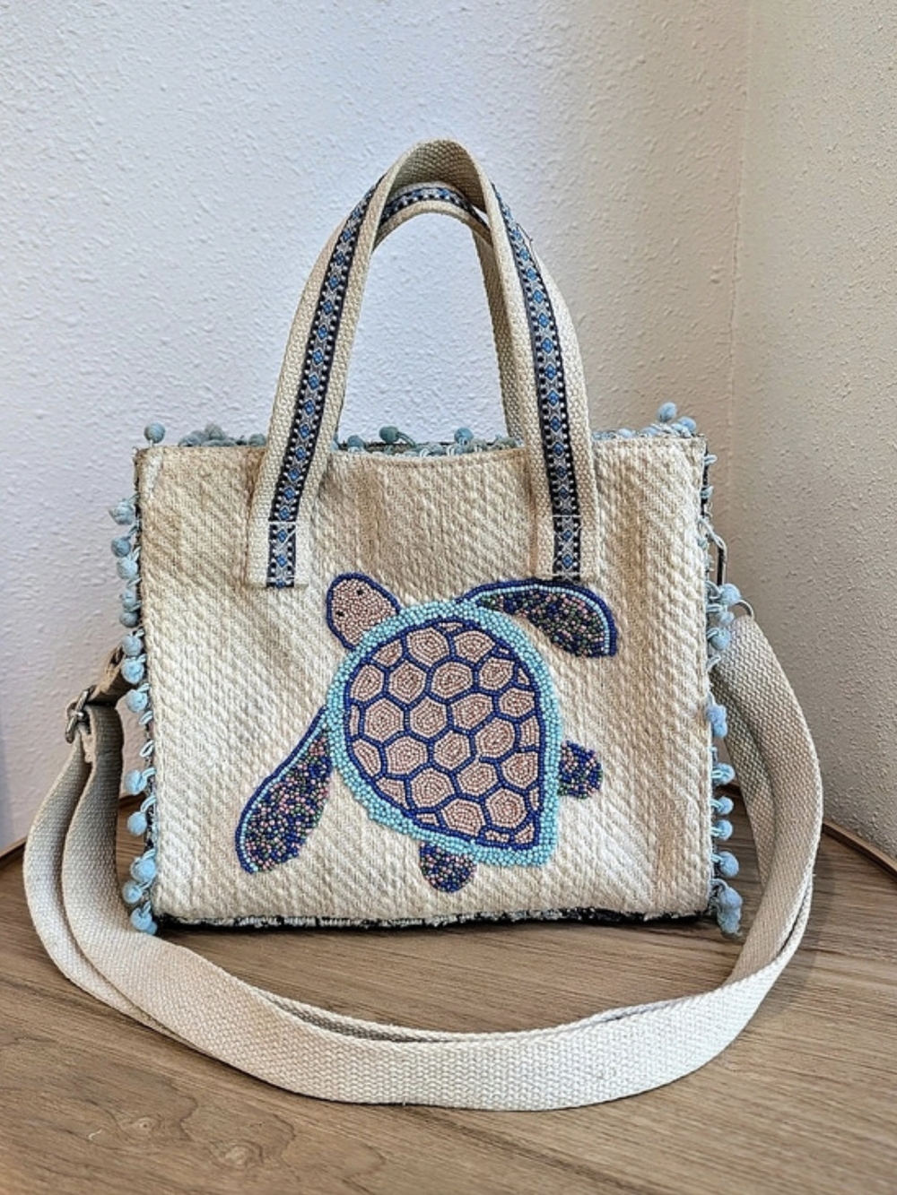 America & Beyond Beaded Turtle Embroidered Canvas Crossbody Tote in Cream & Blue
